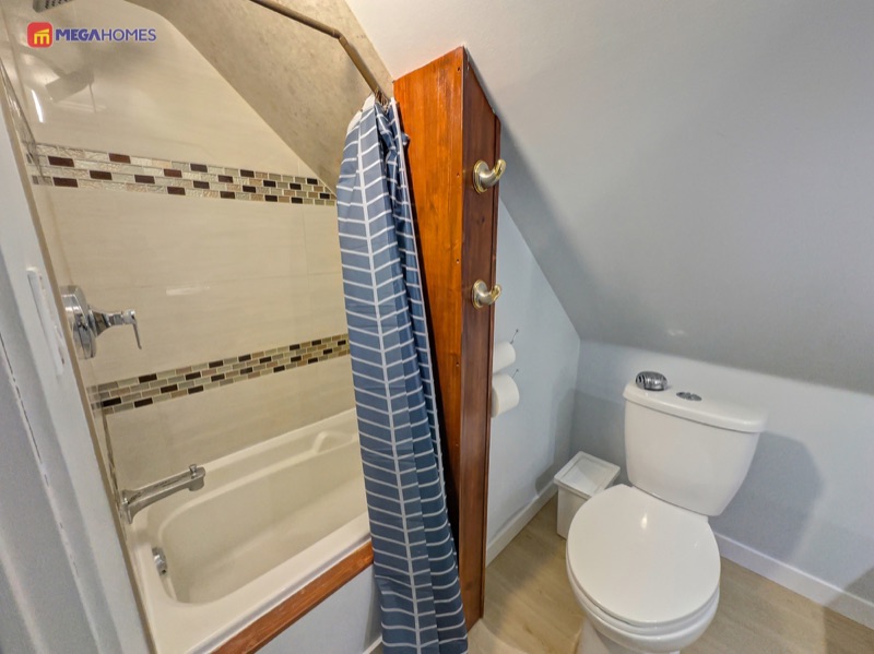 Upper level four piece bathroom with tub and shower