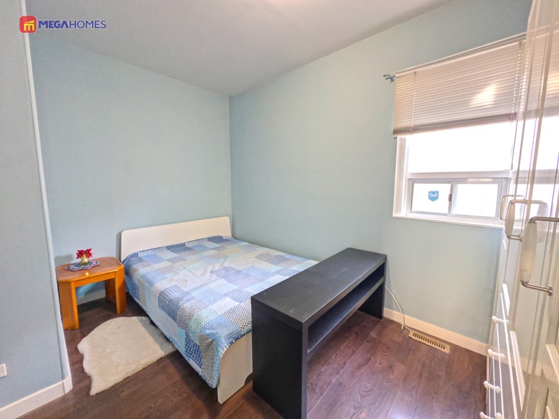 Primary bedroom on the main floor with laminate flooring