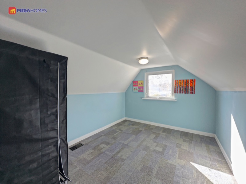 Third bedroom on the upper level with carpet flooring