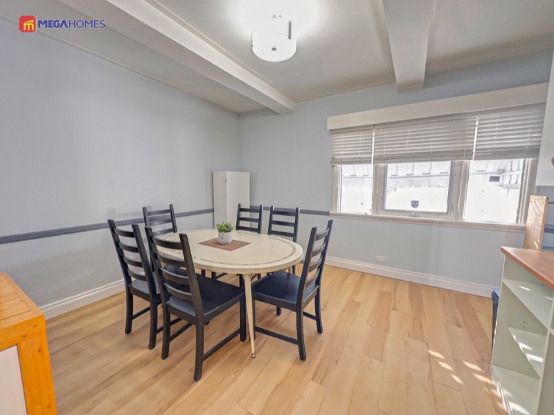 Bright dining area with vinyl plank flooring carried through from the kitchen