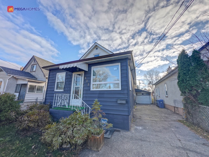 Front elevation showing vinyl siding at the front and stucco on the remainder