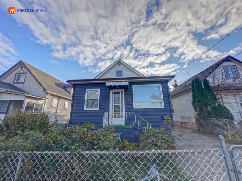Front exterior of 622 Burrows Avenue with the attached garage and deep driveway