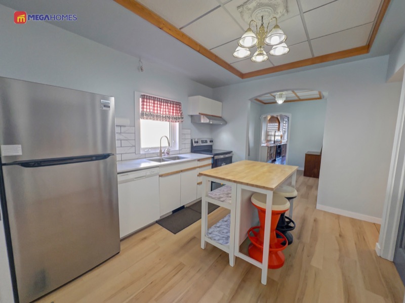 Newly updated kitchen with quartz countertops, tile backsplash and new stove
