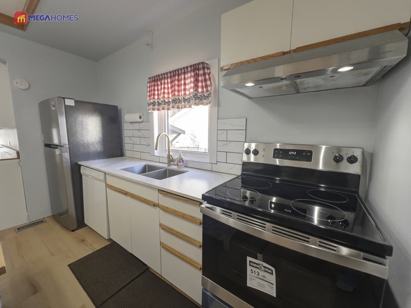 Kitchen with brand new fridge and vinyl plank flooring