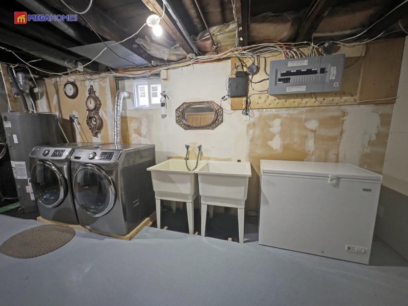 Large basement laundry and utility room with laundry sink