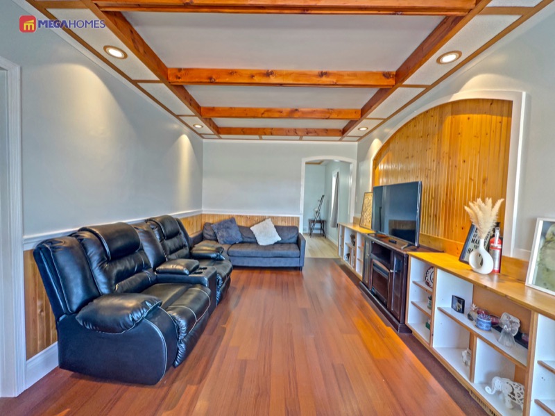 Living room with coffered ceiling, natural wood beams and built-in entertainment wall