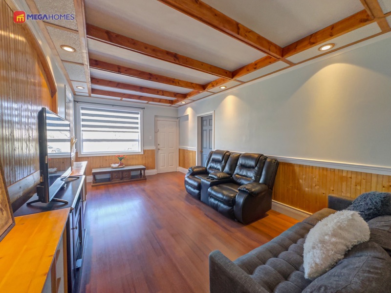 Living room looking toward the front window with recessed pot lighting