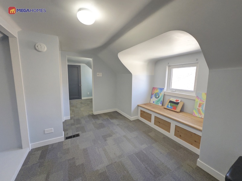 Upper level loft with a built-in window bench between the two upper bedrooms
